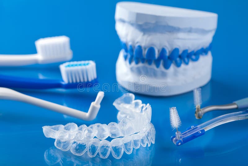 Closeup shot of individual tooth tray for whitening and toothbrushes