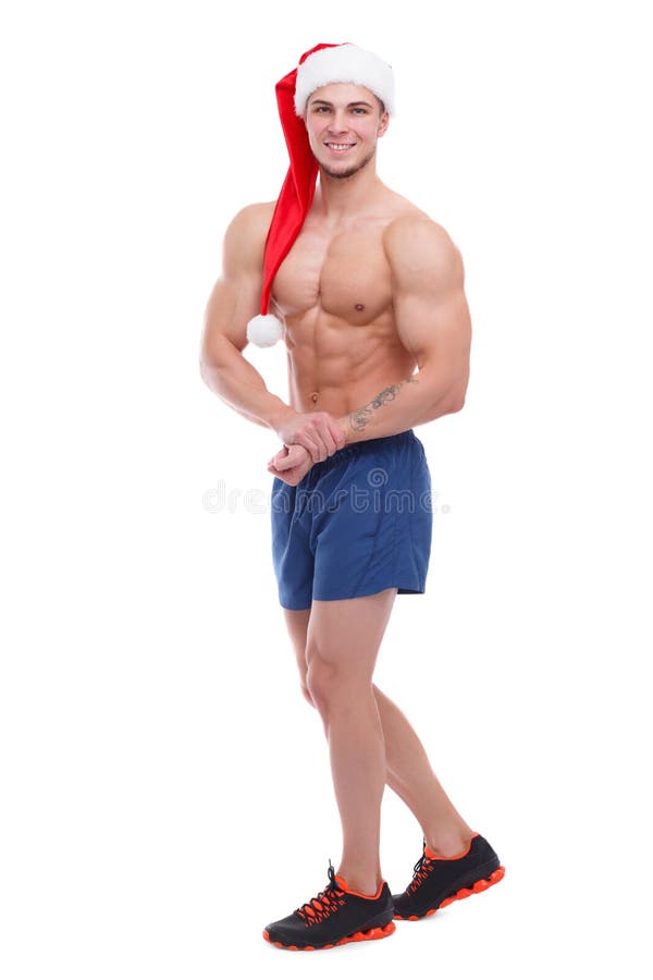 Indivíduo atlético considerável com torso despido e o chapéu de Santa que levantam mostrando fora seus músculos Isolado fotografia de stock royalty free Indivíduo atlético considerável com torso despido e o chapéu de Santa que levantam mostrando fora seus músculos Isolado fotografia de stock royalty free