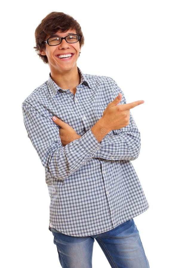 Smiling young man with glasses wearing blue jeans and checkered shirt shows forefinger on something. Isolated on white background, mask included. Smiling young man with glasses wearing blue jeans and checkered shirt shows forefinger on something. Isolated on white background, mask included