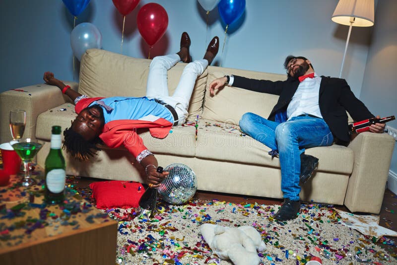 Posh guys with bottles of alcoholic drinks sleeping on sofa after party. Posh guys with bottles of alcoholic drinks sleeping on sofa after party