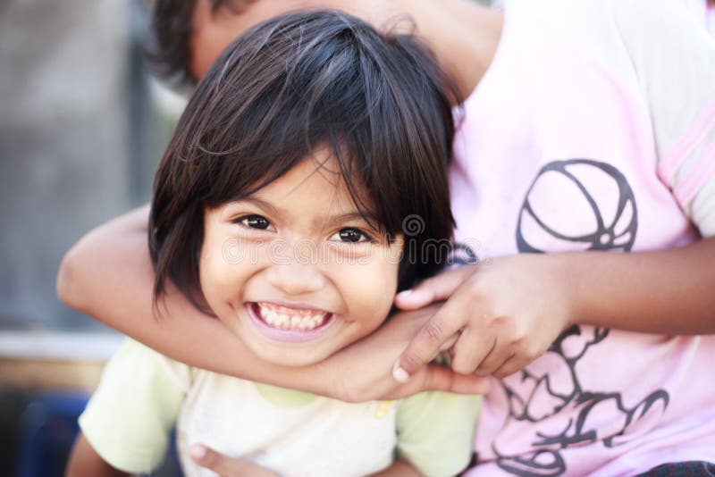 Poverty children playing happily outdoors in a village despite poor living