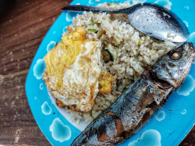 Indonesian Breakfast, Fried Rice with Fried Egg and Fried Fish Serve on