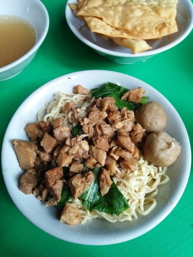 Typical Indonesian chicken noodles served with pangsit goreng or crispy fried woonton and bakso or meatball soup.