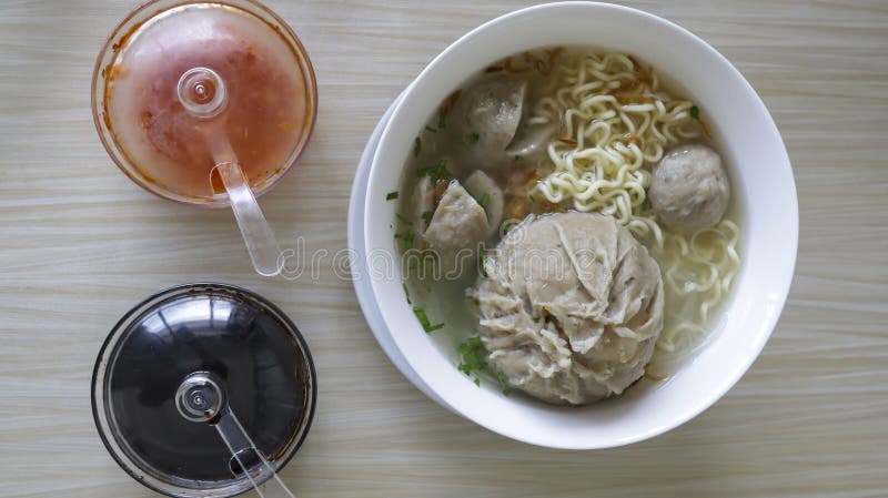 Indonesian famous foodstreet Bakso or baso is a meatballs served with the soup if beef broth, noodle, additional soy sauce and some chilli sauce.