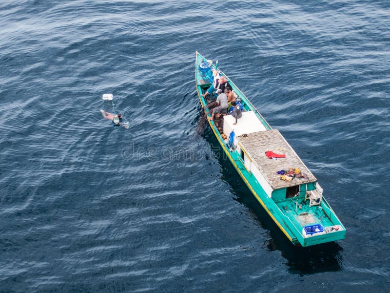 Borneo, Indonesia - 2015: Indonesian fisherman fishing offshore of Balikpapan city on Borneo Island