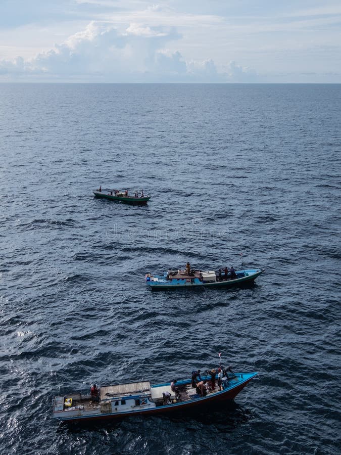 Borneo, Indonesia - 2015: Indonesian fisherman fishing offshore of Balikpapan city on Borneo Island