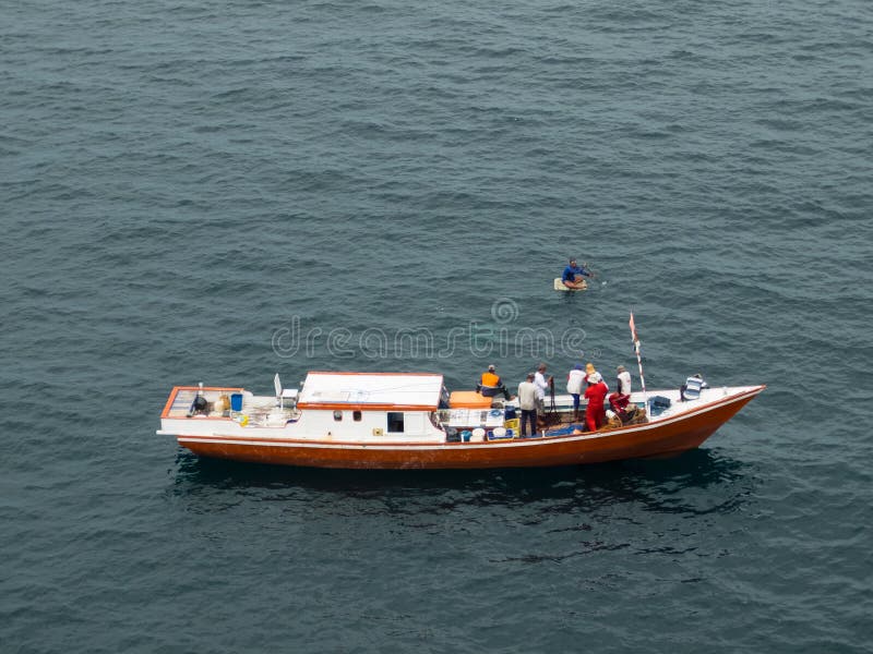 Borneo, Indonesia - 2015: Indonesian fisherman fishing offshore of Balikpapan city on Borneo Island