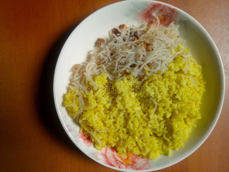 Indonesian Traditional Yellow Rice Served with White Plate Stock Photo