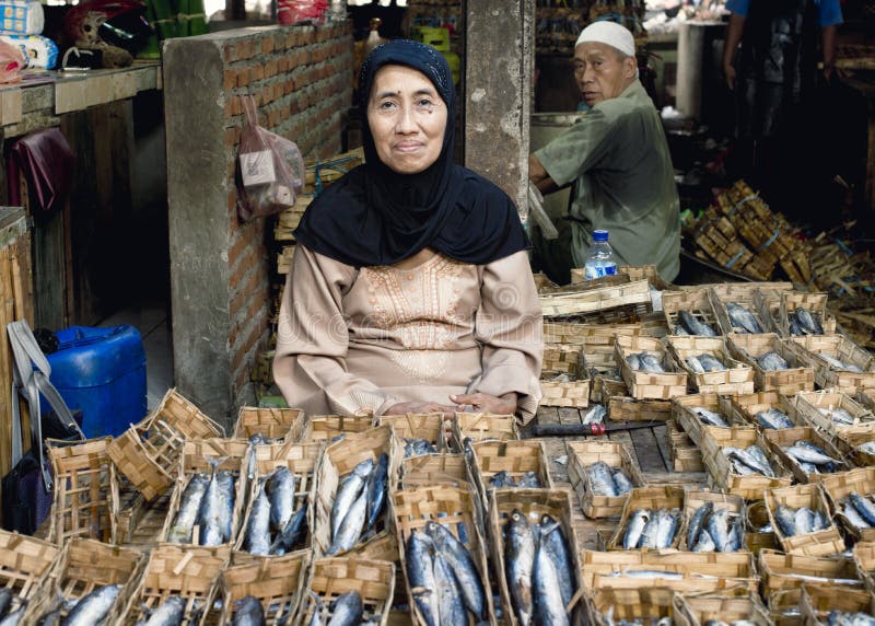 Indonesian woman selling dried fish at the market