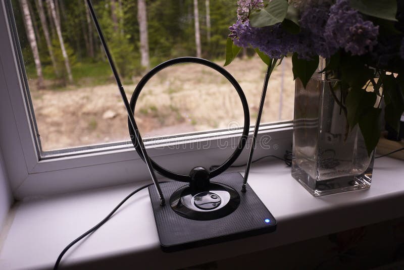 Indoor antenna for receiving TV signal. Set near the window and catches the TV. Details and close-up.