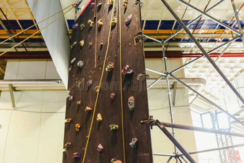 Indoor climbing wall for children during a fair. Female climbing high risk building stock images, royalty-free photos and pictures