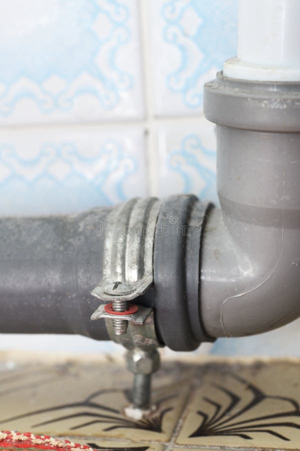 Indoor Plastic Sewer Pipe with Fixing for Floor and Wall. Stock Image
