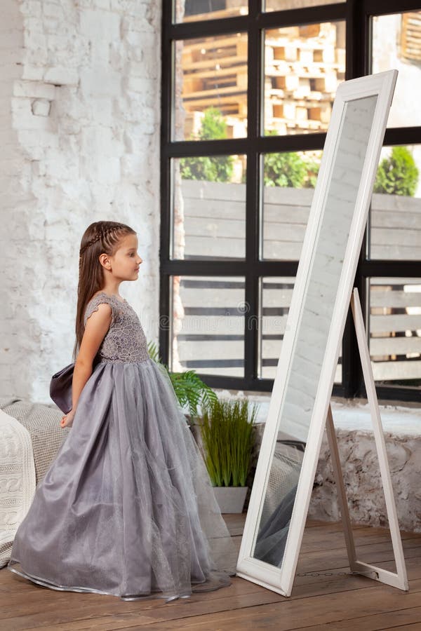Indoor portrait of a little charming girl wearing in a beautiful dress. stock images Indoor portrait of a little charming girl wearing in a beautiful dress. stock images