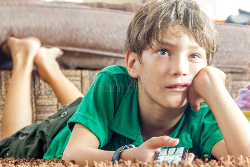 Indoor portrait of young boy watching tv