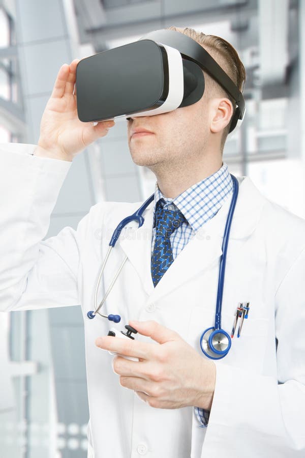 Indoors shot of male doctor wearing VR glasses stock photography Indoors shot of male doctor wearing VR glasses stock photography