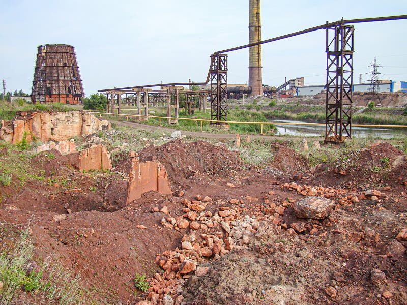An industrial area with signs of recent excavation work, a large rock pile, sparse vegetation, and abandoned structures The overcast sky suggests neglect or abando Kostiantynivka, Ukraine, 06-15-2013. Sparse use stock images, royalty-free photos and pictures