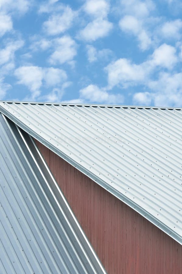 Industrial building roof sheets, grey steel rooftop pattern, bright summer clouds cloudscape, blue sky, rifled roofing panels