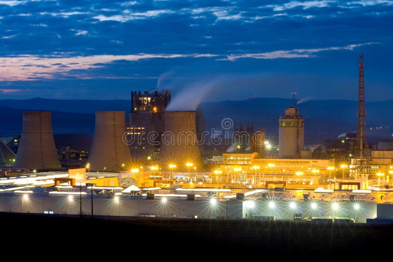 A grate industrial complex at the outskirts of a city. Industrial lights stock images, royalty-free photos and pictures