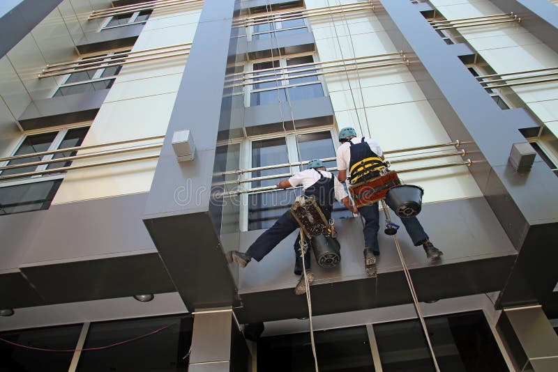 Industrial Climbers Washing Facade of a Modern Building