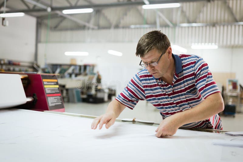Industrial Clothing Designer Working According To Scheme Stock Photos