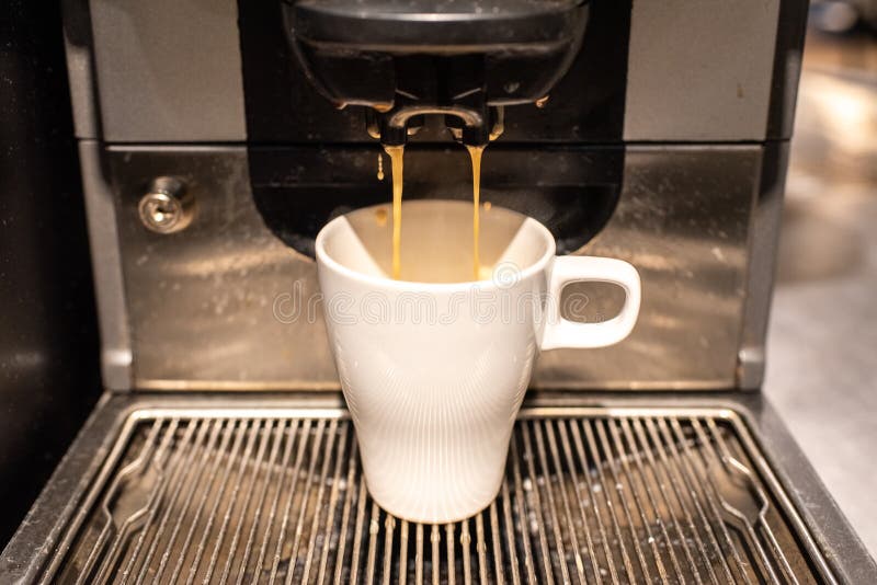 Industrial Coffee Maker Preparing a Coffee with Milk Stock Photo