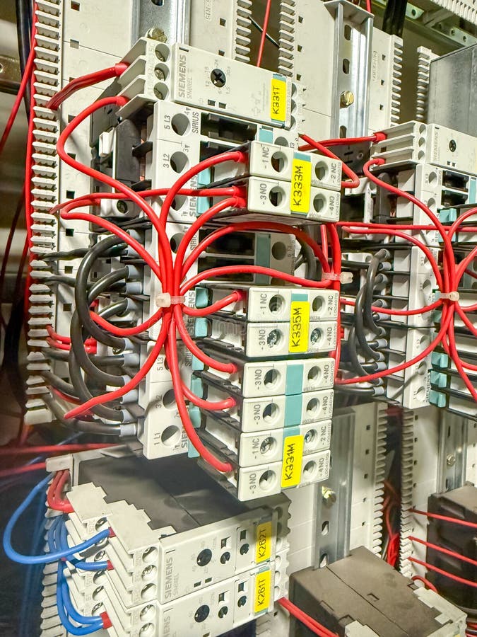 Industrial electrical control cabinet with siemens components contactors relays and structured wiring system inside a стоковое фото
