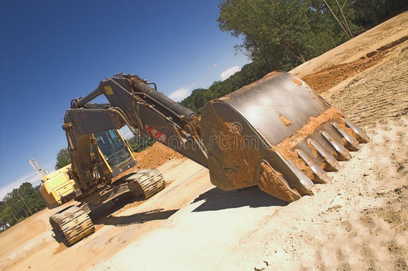 An industrial excavator at a construction site. Track hoe construction excavator stock images, royalty-free photos and pictures