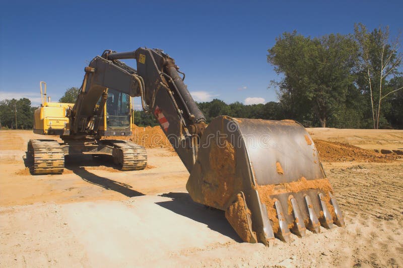 An industrial excavator at a construction site. Track hoe construction excavator stock images, royalty-free photos and pictures