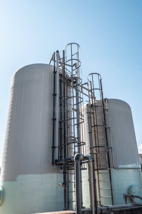 Industrial fiberglass tanks with metal ladder and flange royalty free stock photography Industrial fiberglass tanks with metal ladder and flange royalty free stock photography