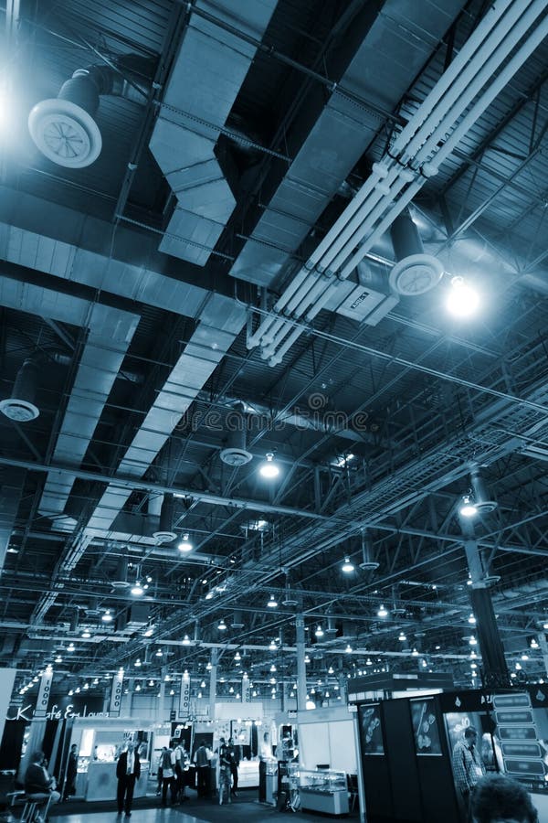 Huge industrial space hosting a trade show. Industrial lights stock images, royalty-free photos and pictures