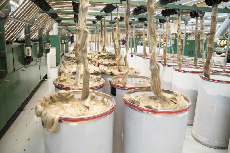 Industrial loom on textile. Flax processing plant, fabric production. Flax is made. A workshop at a textile factory. royalty free stock photography