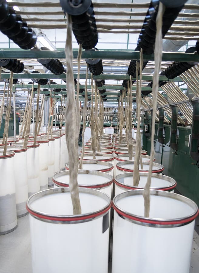 Industrial loom on textile. Flax processing plant, fabric production. Flax is made. A workshop at a textile factory. stock photography