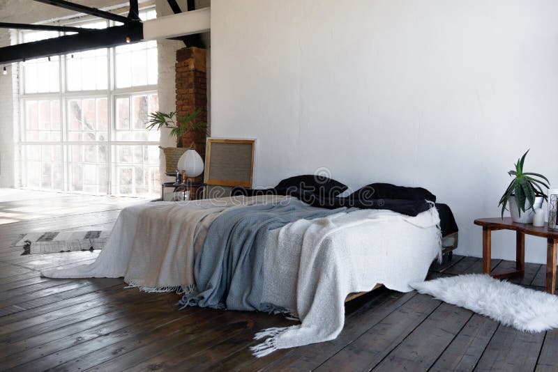 Industrial open space loft interior of a bedroom with big windows filled with daylight. Industrial open space loft interior of a bedroom with big windows filled royalty free stock image Industrial open space loft interior of a bedroom with big windows filled with daylight. Industrial open space loft interior of a bedroom with big windows filled royalty free stock image