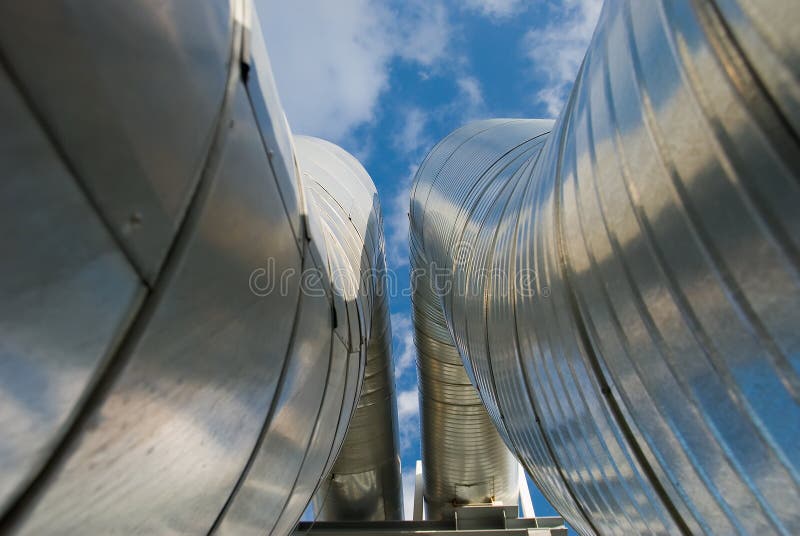 Industrial pipelines against blue sky.