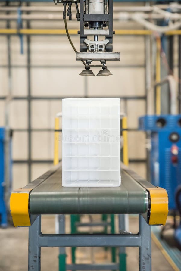 Industrial robot working in plastic factory stock photography