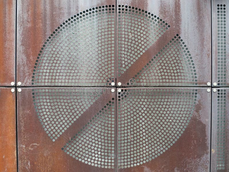 Industrial rusty metal plates with round perforated circular grid pattern