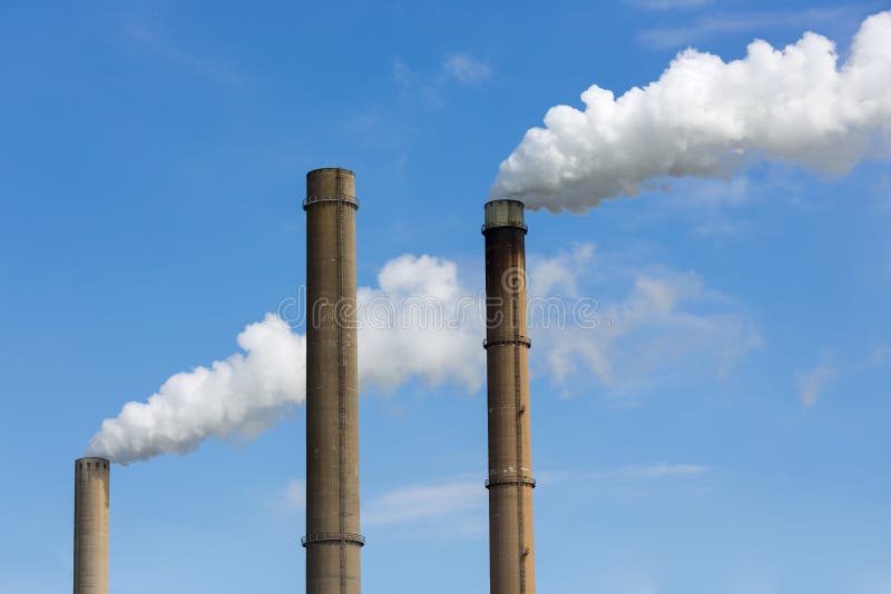Industrial smoke stacks of a power plant. royalty free stock image