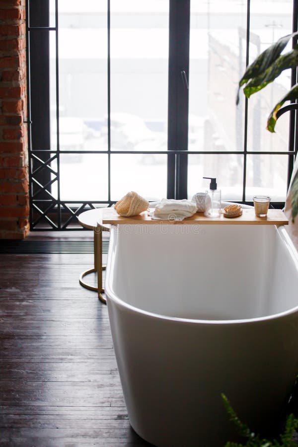 Modern Bathroom with Freestanding White Acrylic Bathtub and Black Loft