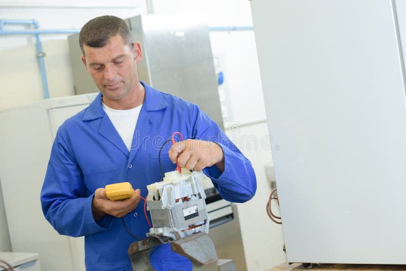 Industrial technician reading voltmeter stock photo