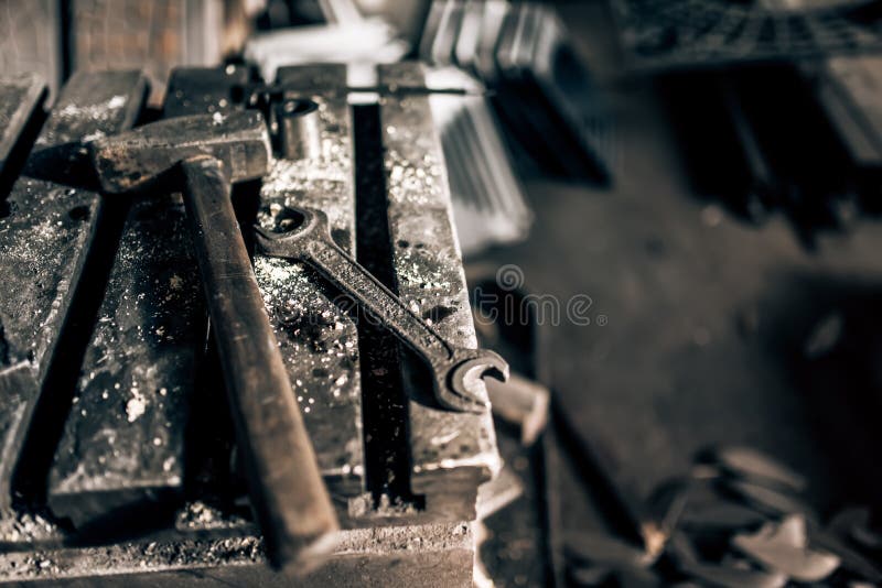 Industrial tools in old factory, metal table with mechanic wrench and hammer