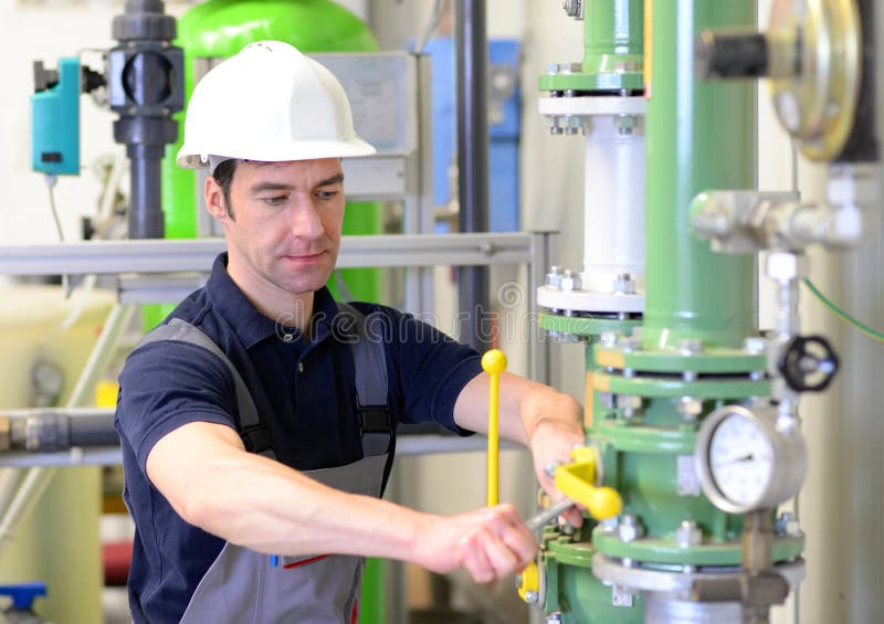 Industrial Worker Repairs Machines and Equipment in a Refinery Stock