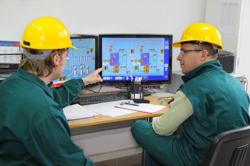 Industrial workers in control room stock photo