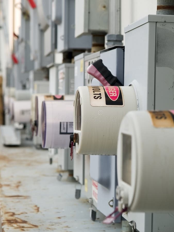 Stock photo of a row of rusty industrial power cutoffs and meters. Stock photo of a row of rusty industrial power cutoffs and meters.