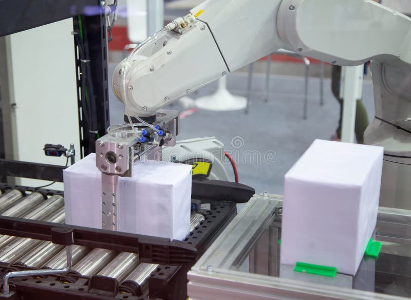 Industry automated robot arm loading and unloading box in production line. Industry automated robot arm loading and unloading box in production line