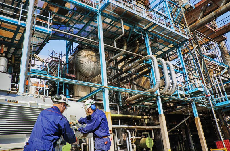 Industry workers inside oil and gas refinery stock image Industry workers inside oil and gas refinery stock image