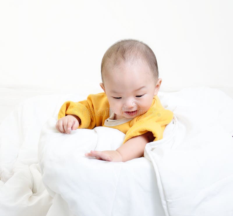 Infant child baby boy looking down