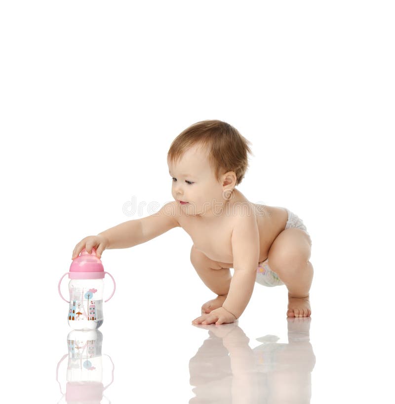 Infant child baby girl toddler sitting with feeding bottle full off fresh water on a white