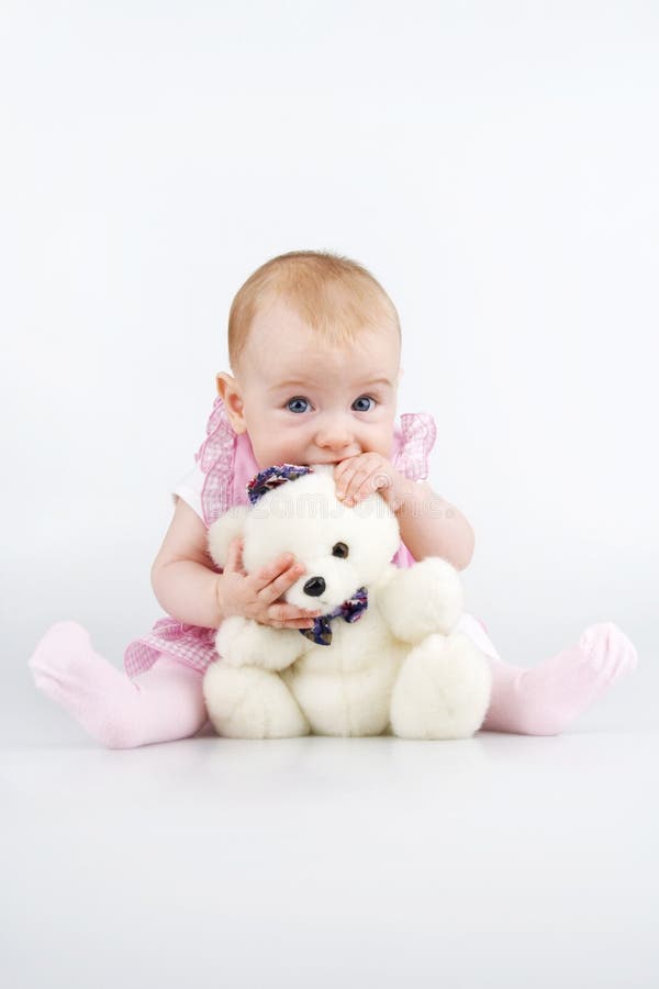 Infant with teddy - bear.