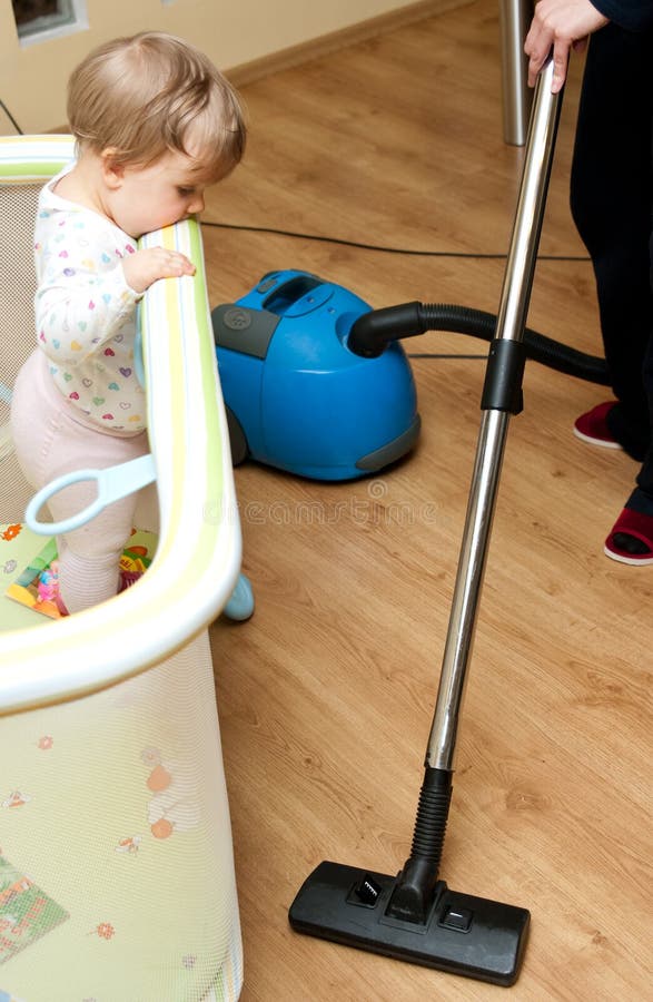 Infant and Vacuum Cleaner stock image. Image of looks 19164405
