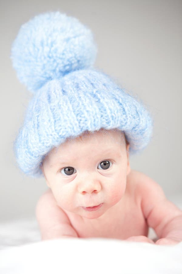 Infant wearing blue knit hat